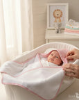 Stork And Baby pink bamboo hooded baby towel with white terry cloth lining and delicate pattern