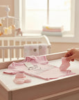 Stork And Baby pink 100% combed cotton baby girl's romper with bunny and heart embroidery and lace trim.