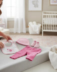 Stork And Baby pink elephant 5-piece newborn gift set with bodysuit, pants, socks, bib, and cap.