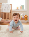 Stork And Baby Mothers Choice Inf Pink Kneeguards protect baby's knees while crawling. Pink with white pattern.