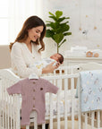 Stork And Baby pink waffle knit long sleeve romper with wooden buttons, perfect for newborns.