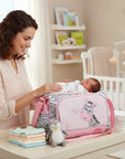 Stork And Baby pink square diaper bag with zebra and butterfly embroidery, grey zebra print sides, and pink straps.