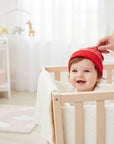 Stork And Baby red striped knit baby hat with soft comfortable fit for chilly weather.