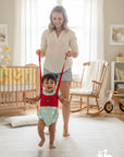 Stork And Baby red baby walking trainer vest with adjustable straps, helping a toddler walk.
