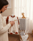Stork And Baby cream velour baby grower with brown polka dots and "sweet dreams" embroidery. Features brown cuffs and feet.