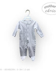 Stork And Baby white long-sleeved babygrow with snap closures and footies. Soft, breathable cotton for everyday comfort.