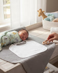 Stork And Baby white double knit bib with tie-up closure, perfect for feeding time spills and drool.