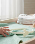 Stork And Baby Mothers Choice white girls alice band with cartoon character detail on a soft mint green baby blanket.