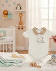 Stork And Baby white 100% combed cotton baby romper with a teddy bear and 'Amore' embroidery, tan collar.