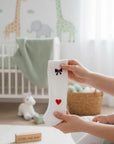 Stork And Baby white infant tights with red heart and black bow detail. Soft, stretchy, and comfortable for everyday wear.