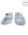 Pair of white baby socks with green patterns on a white background, branded 'Mother's Choice'.