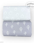 Two rolls of fabric with white patterns on a light gray background, featuring 'Mother's Choice' branding.
