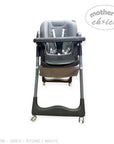Gray high chair with wheels on a white background, featuring 'Mother's Choice' branding.