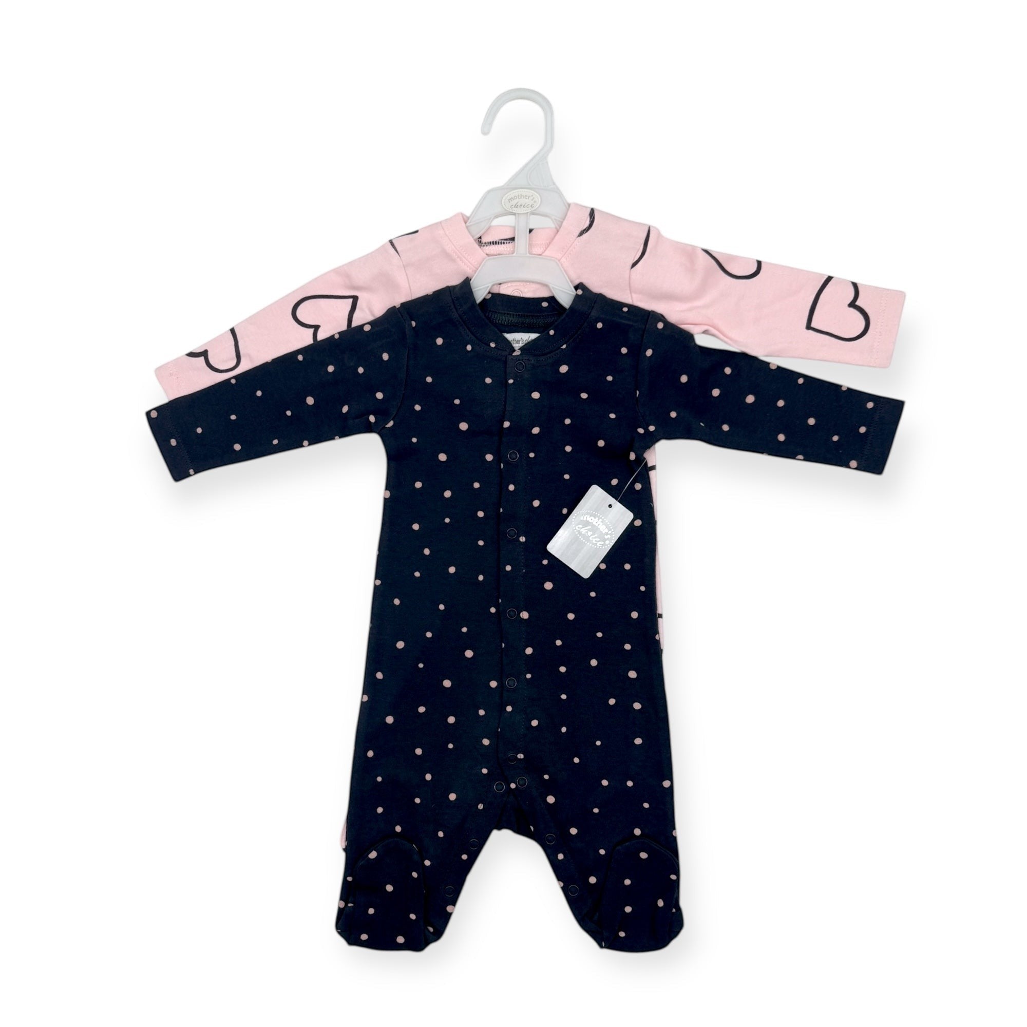 Navy baby onesie with white polka dots on a hanger against a white background