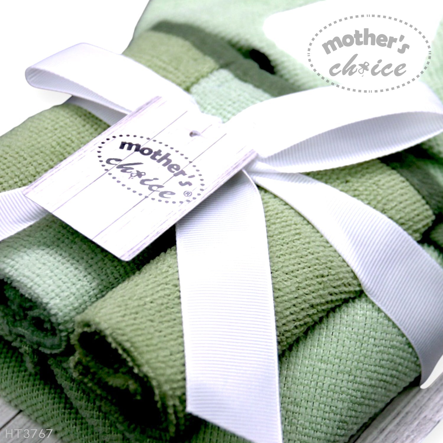 Green baby blankets with a white ribbon and 'mother's choice' tag.
