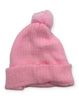 Pink knit beanie with a pom-pom on a white background