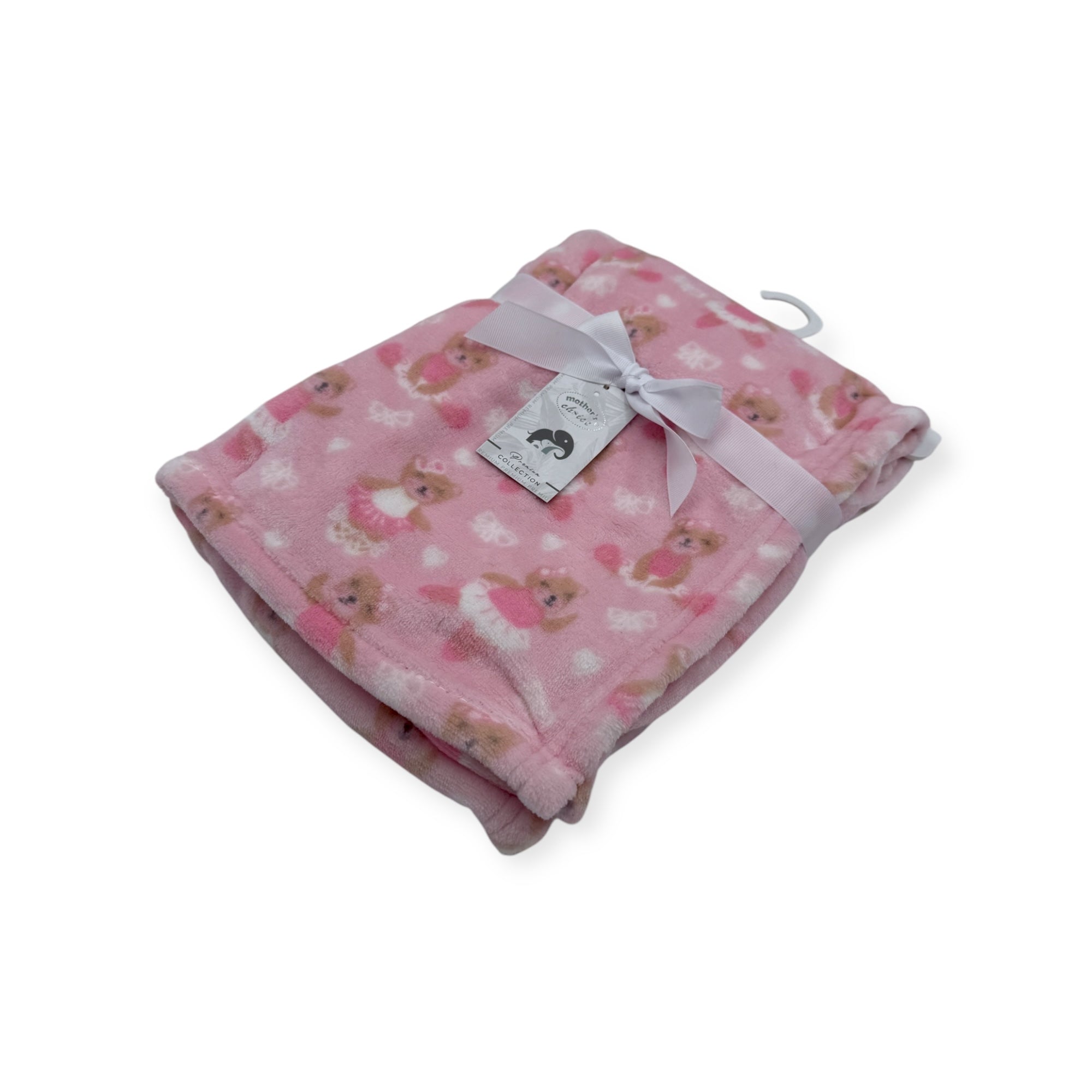 Pink baby blanket with teddy bear pattern and white tag on a white background