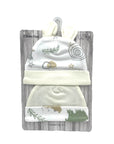Set of two baby caps with patterns on a wooden-textured card packaging.