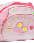 Pink children's bag with butterfly design and 'cute as a button' text on a white background