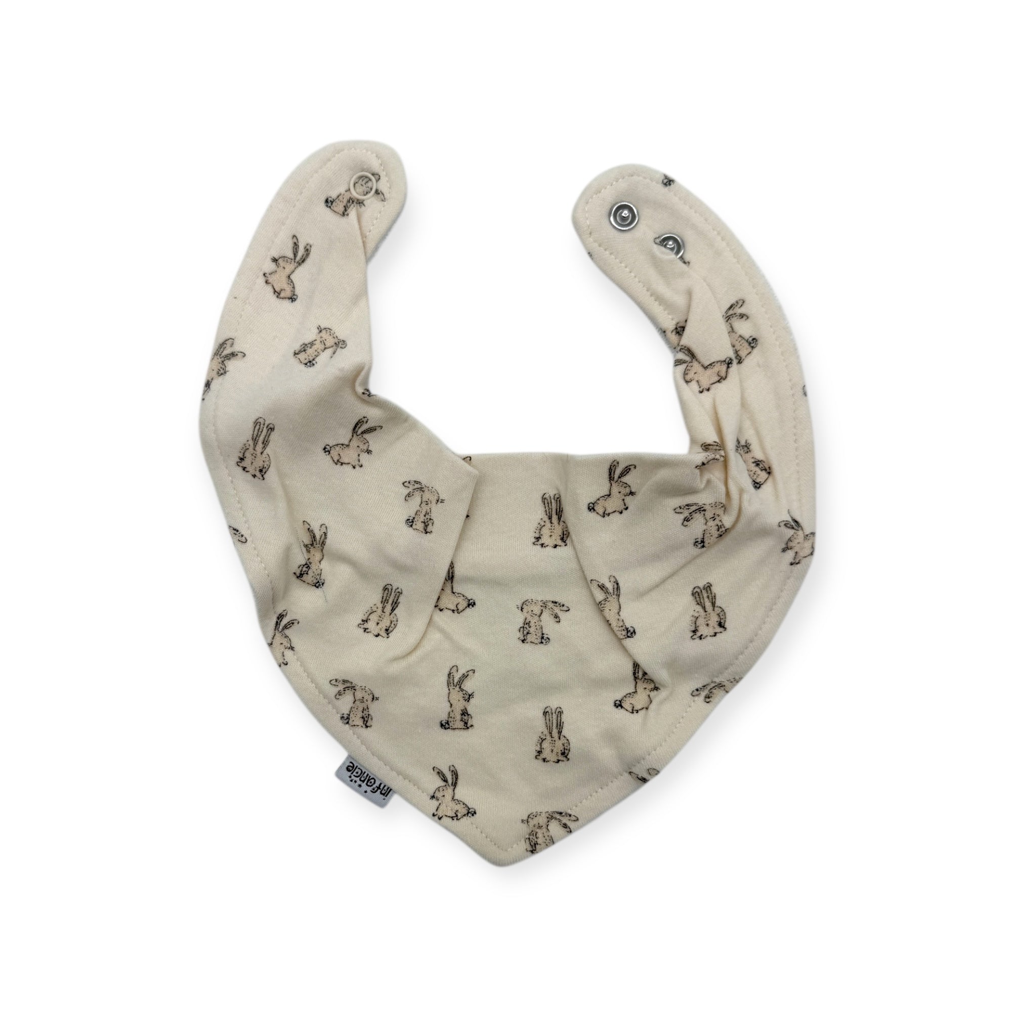 Beige baby bib with animal pattern on a white background