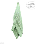 Green baby blanket with white patterns on a white background, branded 'Mother's Choice'.
