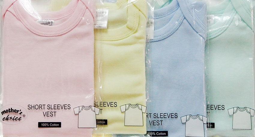 Packaged baby vests in pink, yellow, blue, and green with labels indicating size and material.