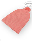 Coral knit beanie with a pom-pom on a white background, branded 'Mother's Choice'.