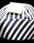 Navy and white striped fabric basket on a black background