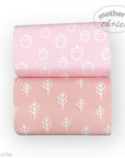 Two pink baby blankets with white acorn and tree patterns, branded 'Mother's Choice'.