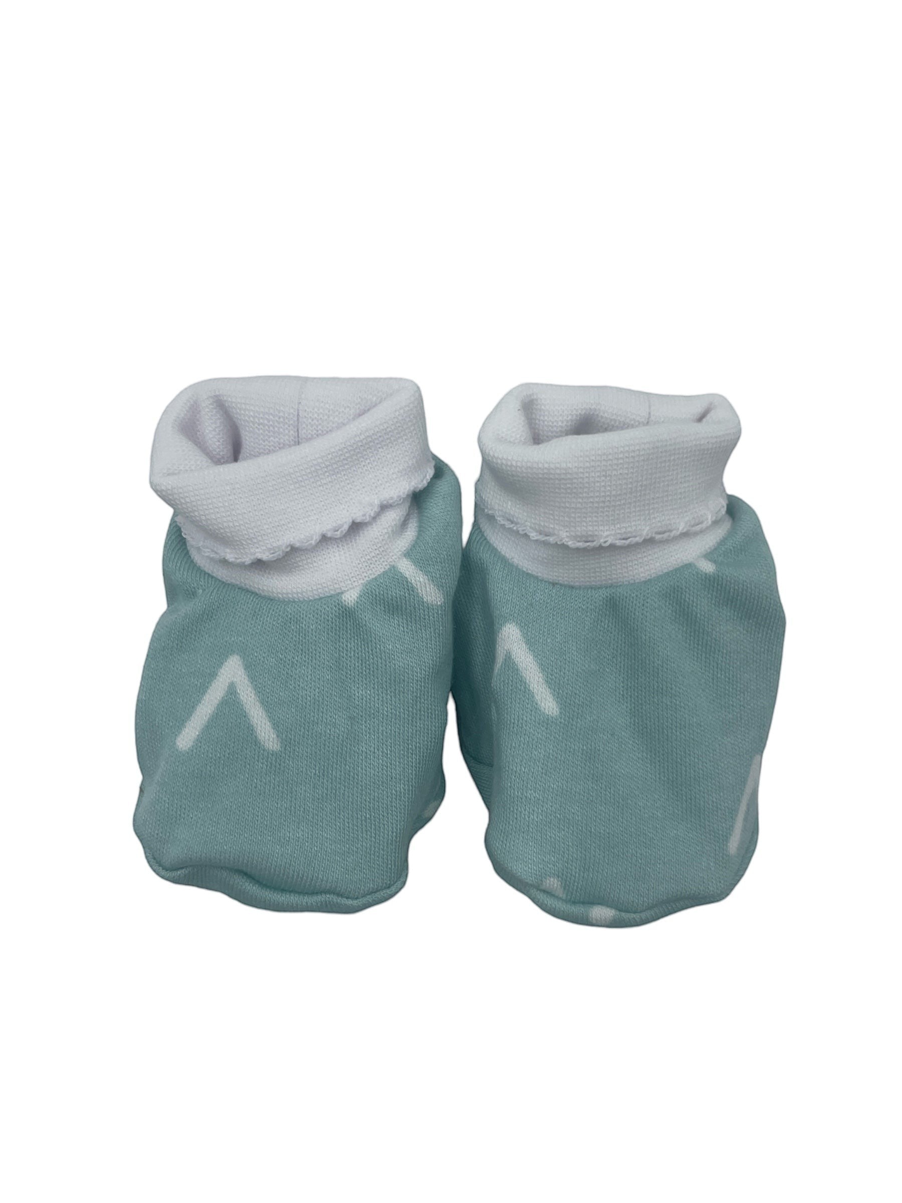 Pair of teal baby booties with gray cuffs on a white background