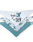 Two baby bibs with helicopter designs and 'Reach for the Sky' text on a white background