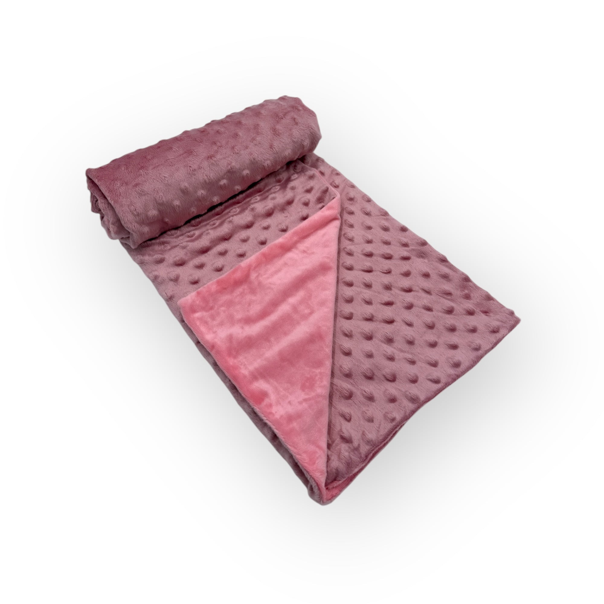 Folded pink blanket with textured surface on a white background