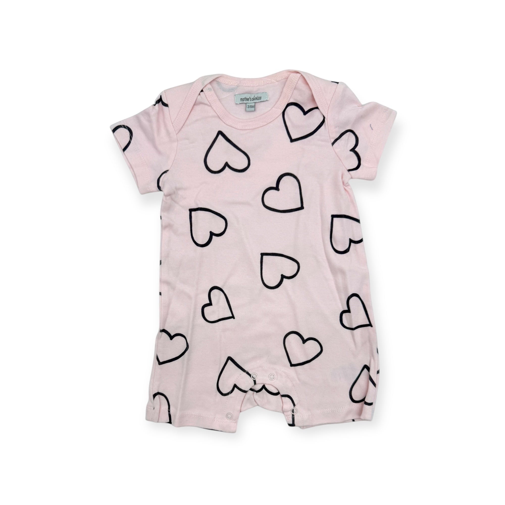 Pink baby romper with black heart patterns on a white background
