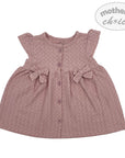 Pink baby dress with bow details on a white background, branded 'Mother's Choice'.