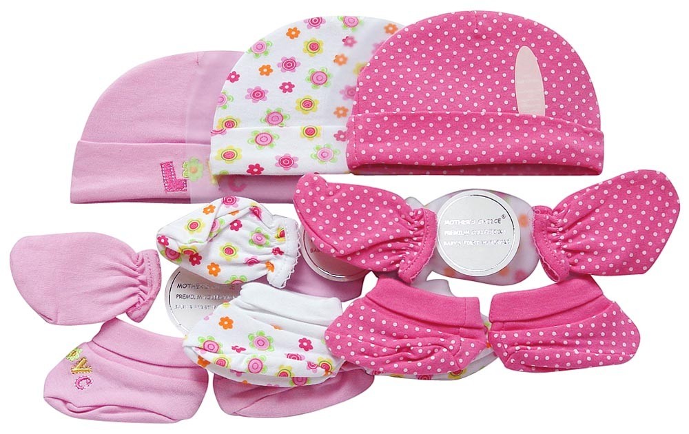 Set of baby hats and booties with floral and polka dot patterns on a white background