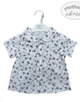 White shirt with black floral pattern on a hanger with 'mother's choice' label.
