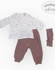 Baby outfit with floral top and brown pants, accompanied by a headband, on a white background.