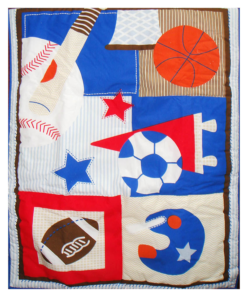 Children's quilt with sports-themed fabric pieces on a white background