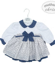 Baby dress with floral pattern and blue trim on a hanger, branded 'Mother's Choice'.