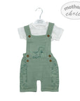 Green dino-themed overalls with a white shirt on a hanger, branded 'Mother's Choice'.