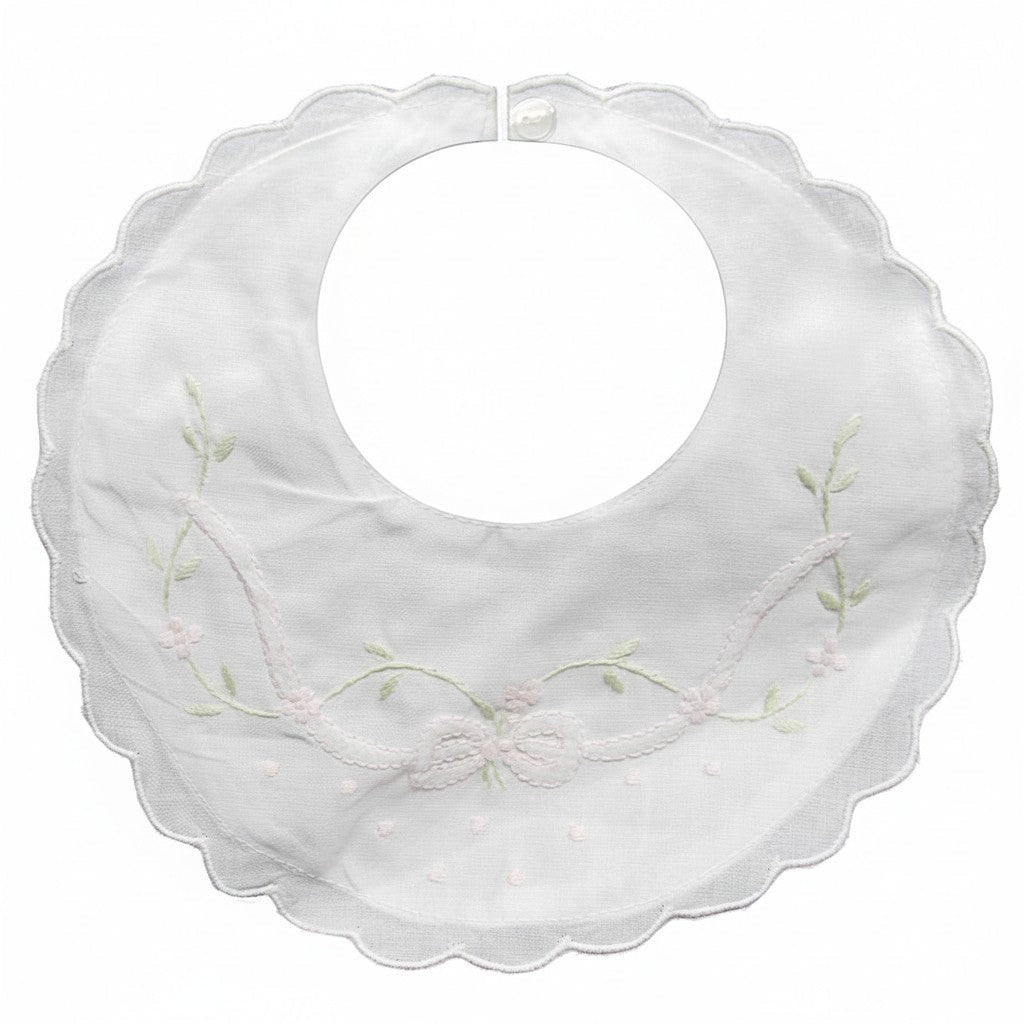 White bib with delicate floral embroidery on a white background