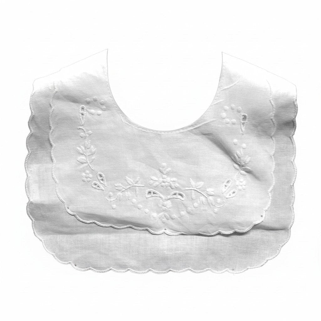 White baby bib with floral embroidery on a white background