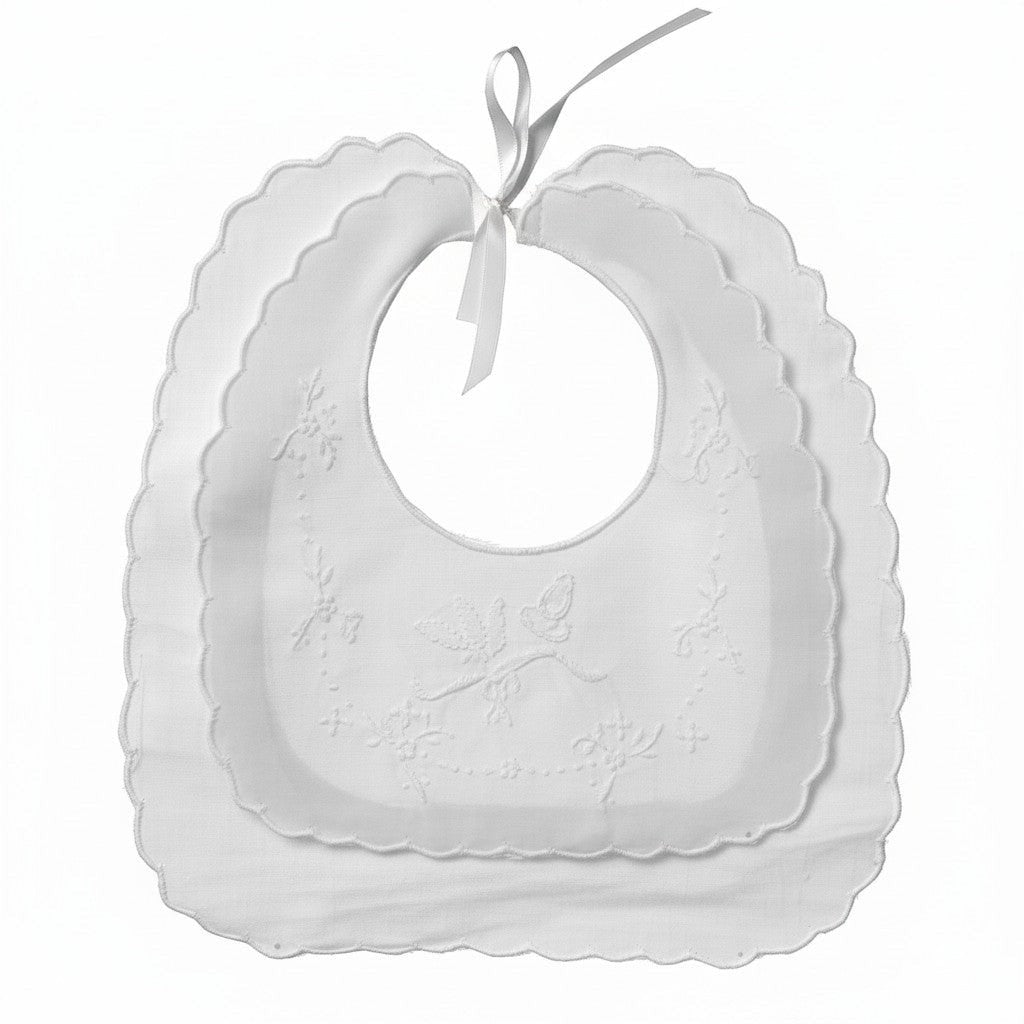 Set of white baby bibs with scalloped edges on a white background