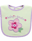 Baby bib with pink flower design and 'baby's garden' text on a light green background