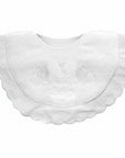White baby bib with lace details on a white background