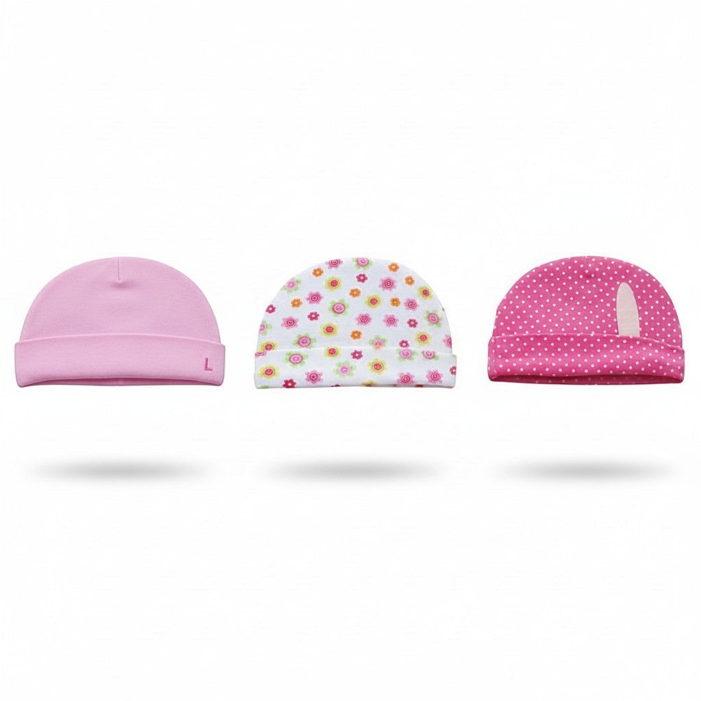 Three pink baby hats with different patterns on a white background