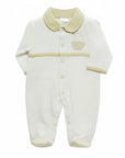 White baby onesie with beige collar and trim on a white background