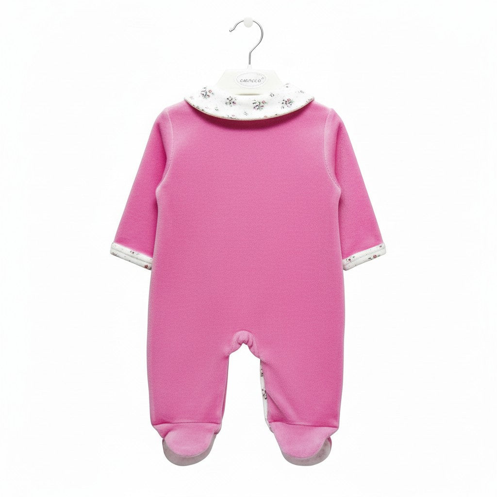 Pink baby onesie on a hanger with a white background