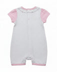 Baby romper with pink sleeves and trim on a white background