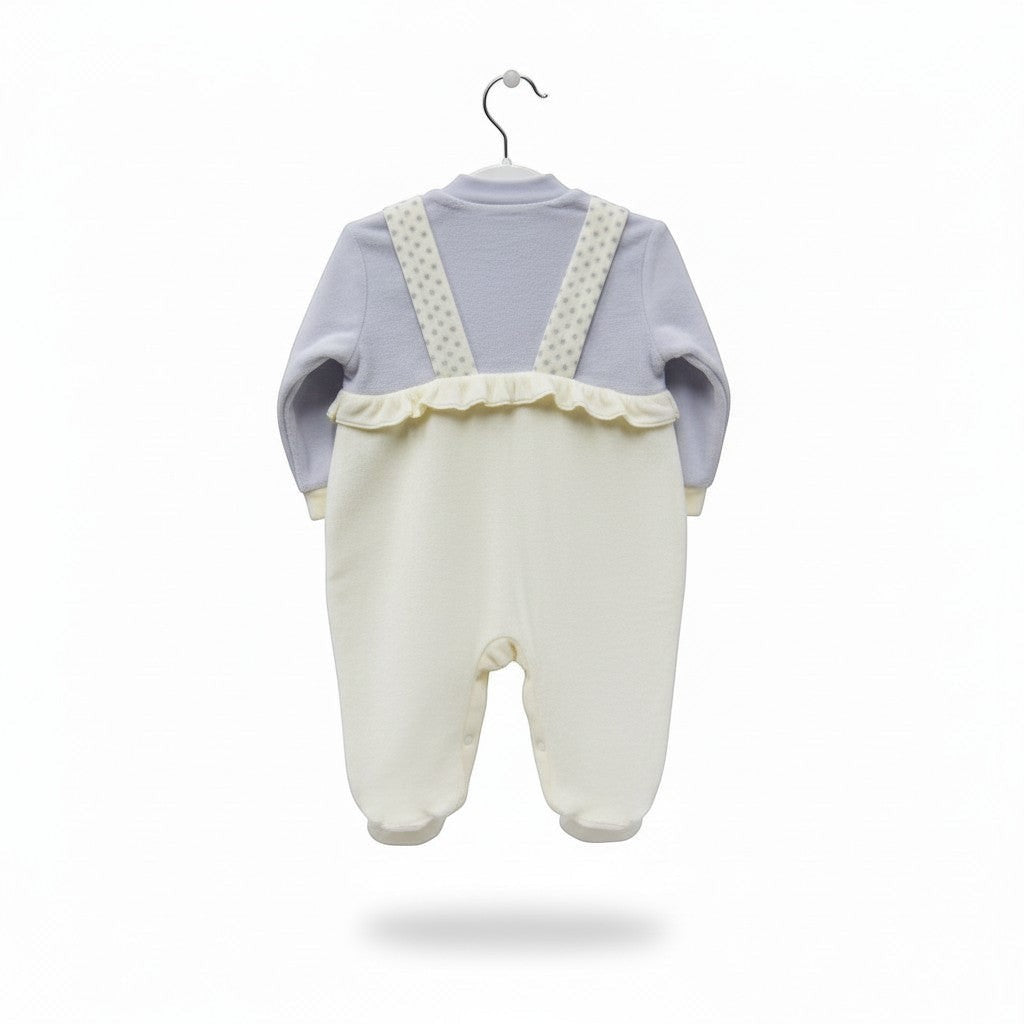 Baby outfit with light blue top and white pants on a hanger against a white background